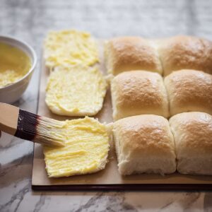 Easy Homemade Sliders Recipe 16 The slider buns are buttered, preparing them for baking or grilling to get a crispy finish.