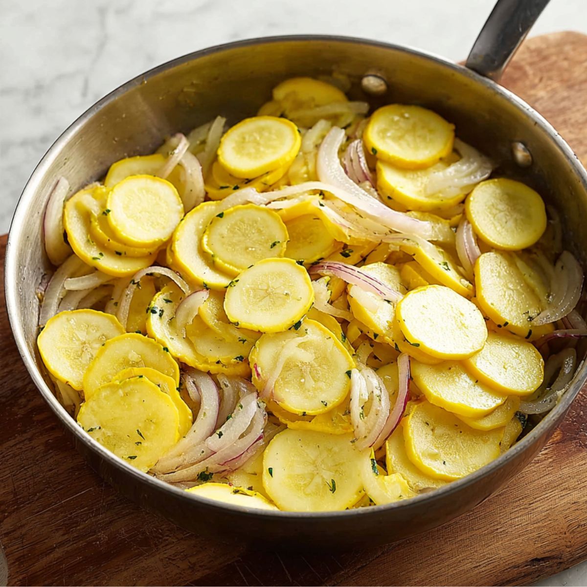 Best Squash Casserole Recipe 11 Sliced yellow squash added to the skillet with sautéed onions, creating a colorful and fresh layer of vegetables.