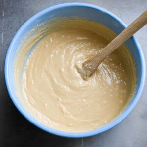 The Best Vegan Strawberry Shortcake Cake 15 A bowl of cake batter, thick and creamy with smooth consistency, ready to be poured into the cake pan for baking."