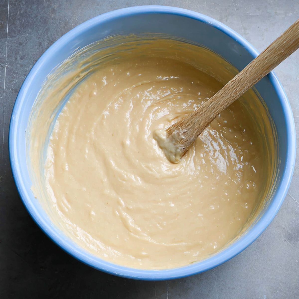 The Best Vegan Strawberry Shortcake Cake 10 A bowl of cake batter, thick and creamy with smooth consistency, ready to be poured into the cake pan for baking."