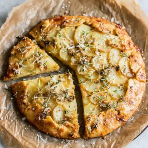 The Best Potato Galette Recipe 18 Golden-brown potato galette with herbs and cheese, sliced and ready to serve.